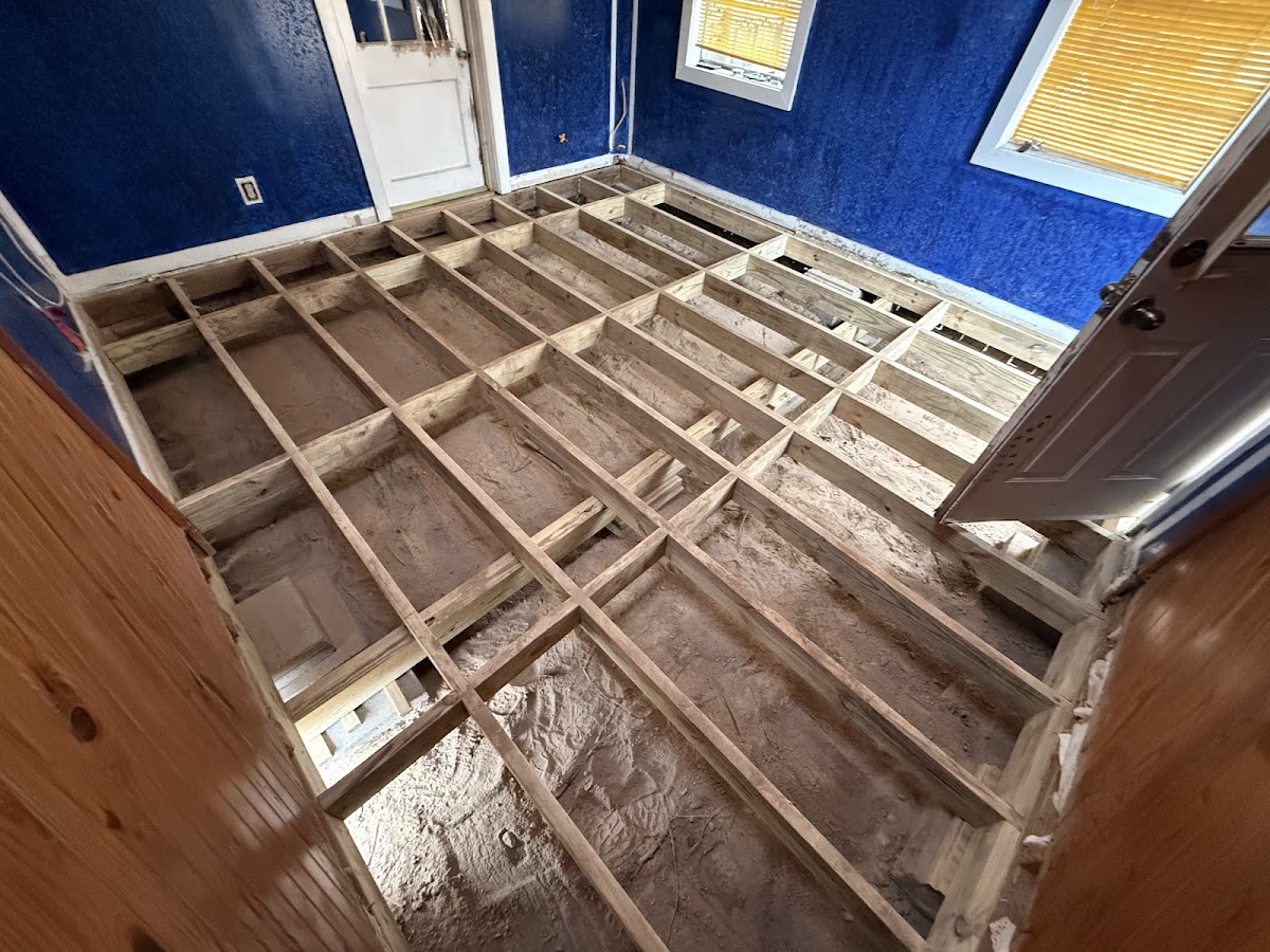 Pier and beam foundation work in progress — exposed floor joists